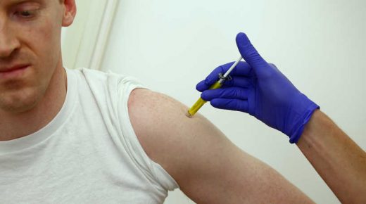 Volunteer Andrew Matzen receives a trial Ebola vaccine at the Centre for Clinical Vaccinology and Tropical Medicine in Oxford, southern England January 16, 2015. Johnson & Johnson said that newly formed groups supporting work on its experimental Ebola vaccine would receive 100 million euros ($115 million) from Europe's Innovative Medicines Initiative to speed development. Photograph taken January 16, 2015. REUTERS/Eddie Keogh (BRITAIN - Tags: SCIENCE TECHNOLOGY HEALTH)