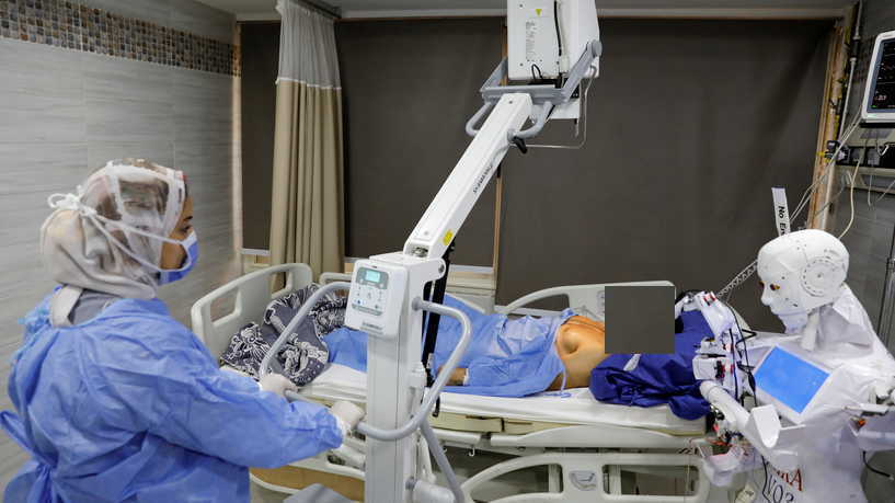 A volunteer is examined by Cira 3, a remote-controlled robot that runs tests on suspected coronavirus disease (COVID-19) patients to limit the human exposure to the virus, amid a second wave of infections in Tanta, Egypt, November 18, 2020. Picture taken November 18, 2020. REUTERS/Mohamed Abd El Ghany