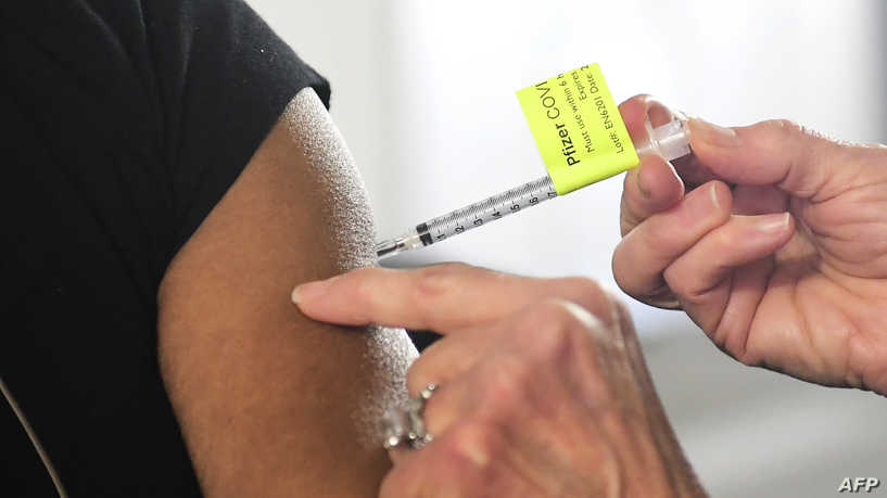 A dose of the Pfizer Covid-19 vaccine is administered on the opening day of a large-scale Covid-19 vaccination site at a parking structure at Cal Poly Pomona University in Pomona, California on February 5, 2021. - The Cal Poly Pomona site is one of two opening in California, with the other located at Moscone Center in San Francisco. According to organizers each site will ultimately have the capacity to administer up to 10,000 vaccine doses per day. (Photo by Frederic J. BROWN / AFP)