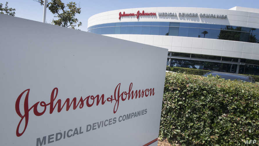 (FILES) In this file photo taken on August 28, 2019 the entry sign to the Johnson & Johnson campus shows their logo in Irvine, California. - Top US health authorities recommended a "pause" in the use of the Johnson & Johnson Covid-19 vaccine "out of an abundance of caution" as they investigate any links between it and blood clots, a regulator said on April 13, 2021. The US Food and Drug Administration and the Centers for Disease Control are assessing the "potential significance" of six reported cases of a rare blood clot in patients who have received the shot, the FDA tweeted. (Photo by Mark RALSTON / AFP)