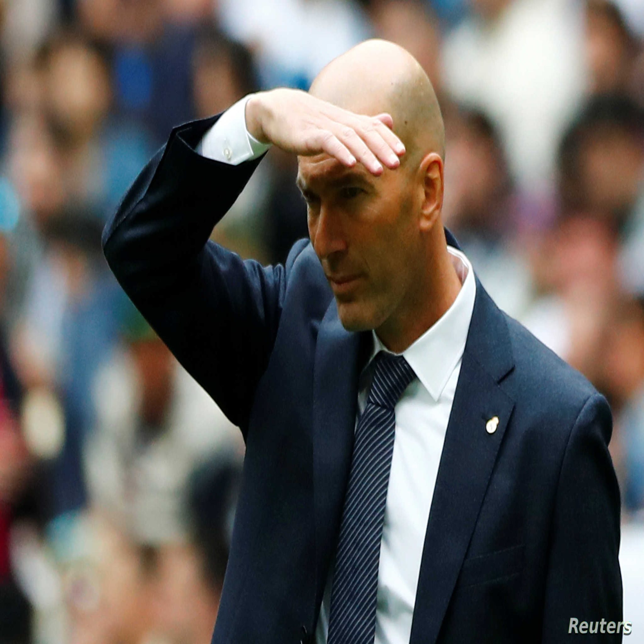 Soccer Football - La Liga Santander - Real Madrid v Real Betis - Santiago Bernabeu, Madrid, Spain - May 19, 2019 Real Madrid coach Zinedine Zidane shields his eyes from the sun REUTERS/Juan Medina