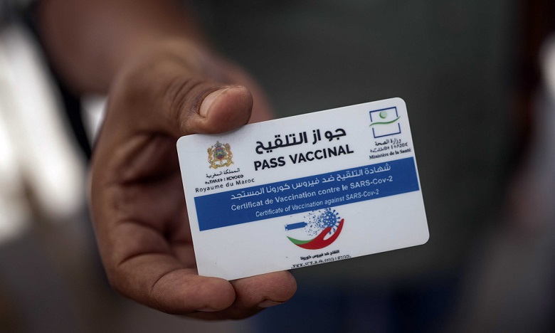 A man displays his vaccine passport before being allowed into a government office, in Rabat, Morocco, Thursday, Oct. 21, 2021. Morocco has made vaccine passports mandatory for people to access governmental offices, malls, gyms and other spaces to push its vaccination campaign. (AP Photo/Mosa'ab Elshamy)