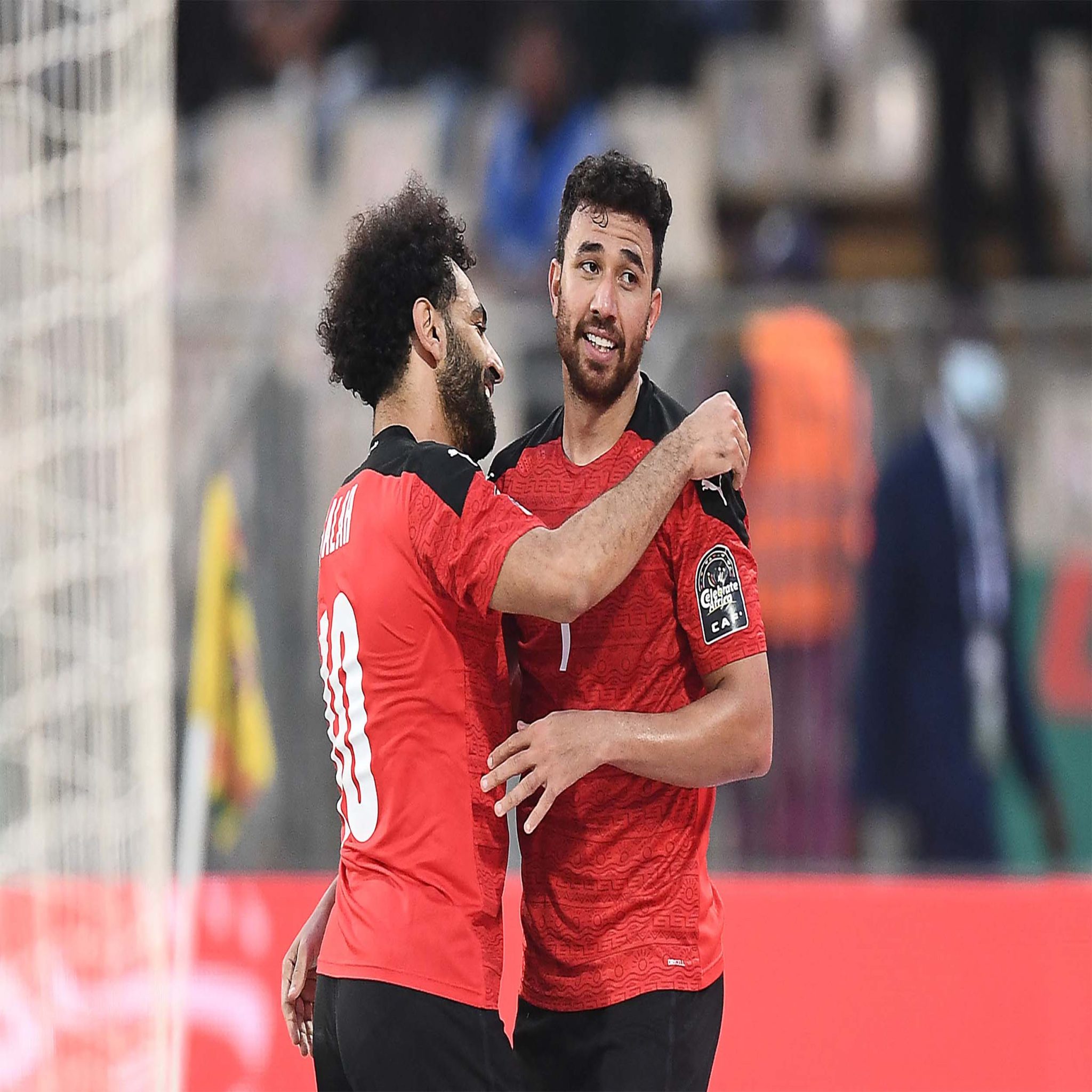 Egypt's midfielder Mahmoud 'Trezeguet' Hassan (R) celebrates with Egypt's forward Mohamed Salah after scoring his team's second goal during the Africa Cup of Nations (CAN) 2021 quarter-final football match between Egypt and Morocco at Stade Ahmadou Ahidjo in Yaounde on January 30, 2022. (Photo by CHARLY TRIBALLEAU / AFP)